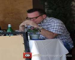 Tom Arnold consuming alcohol